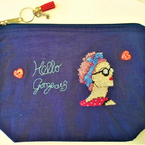 Rockabilly 50s theme small zip up bag with cross stitch lady, heart button detail and wording 'Hello Gorgeous'