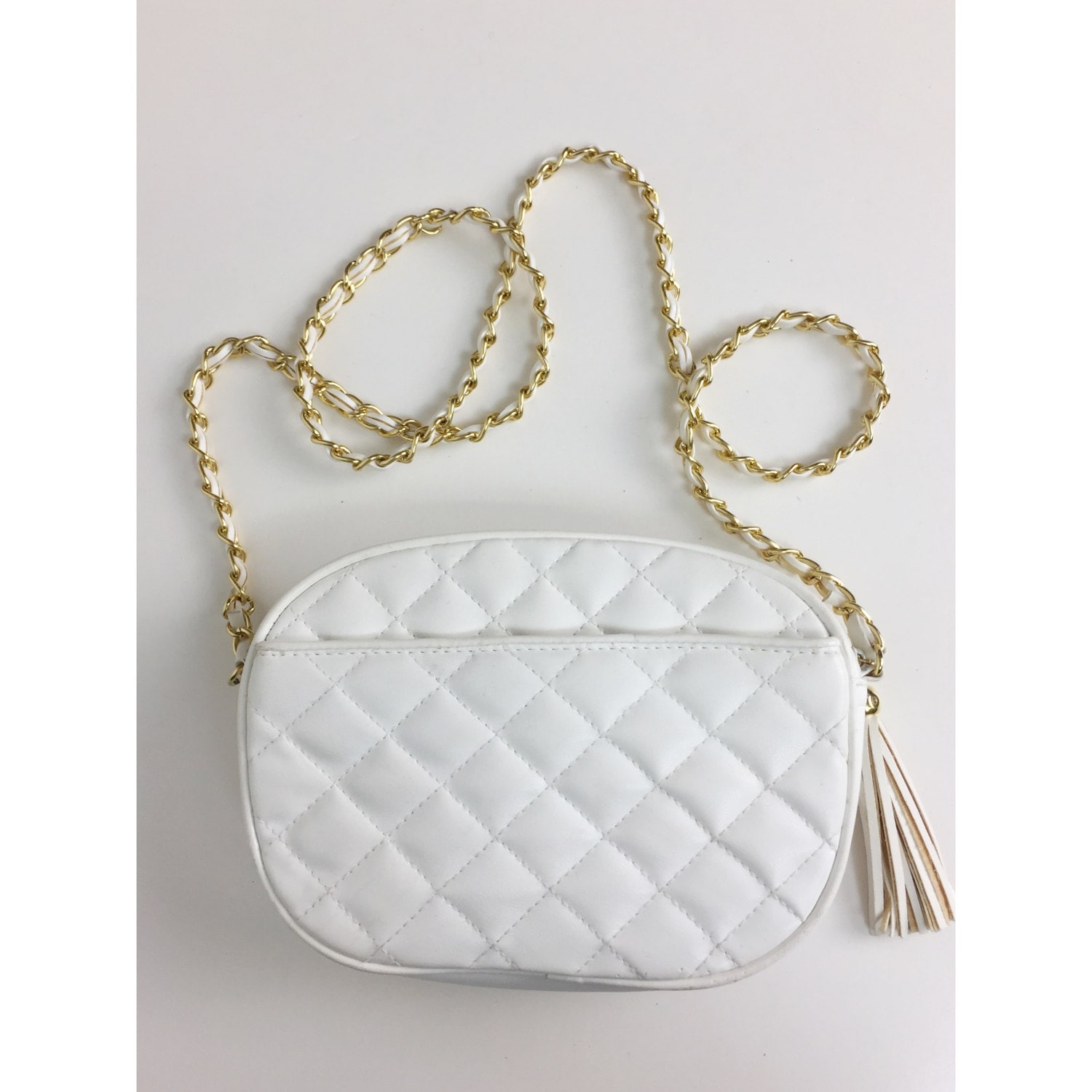 white handbag with gold chain