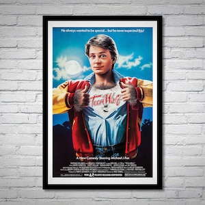 May include: A movie poster for the film "Teen Wolf" starring Michael J. Fox. The poster features a blue sky with clouds, a full moon, and a young man wearing a red and yellow letterman jacket. The man is pulling open his jacket to reveal a white t-shirt with the words "Teen Wolf" printed on it. The poster also includes the text "He always wanted to be special... but he never expected this!" and "A New Comedy Starring Michael J. Fox."
