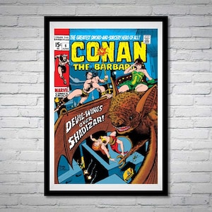 May include: Framed comic book cover featuring Conan the Barbarian. The cover art depicts Conan fighting, a woman in green, and a large bat. Text includes "Conan the Barbarian" and "Devil-Wings Over Shadizar!" The comic is framed in a black frame.
