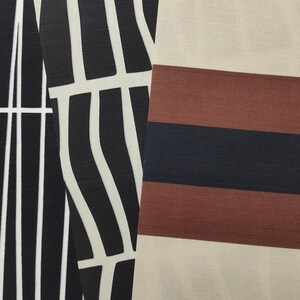 May include: Two distinct fabric swatches are displayed side by side. The left swatch features a black and white abstract pattern of vertical, slightly curved lines. The right swatch displays horizontal stripes in alternating bands of beige, brown, and black.