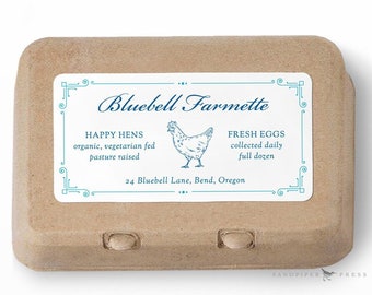 May include: A brown cardboard egg carton with a white label. The label reads "Bluebell Farmette" and includes text about happy hens and fresh eggs. A blue illustration of a hen is also on the label. The carton holds a full dozen eggs.