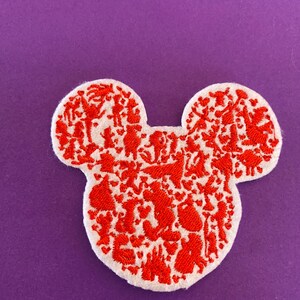 May include: Red embroidered Mickey Mouse head patch with a white background. The patch is filled with small red embroidered images of Disney characters.
