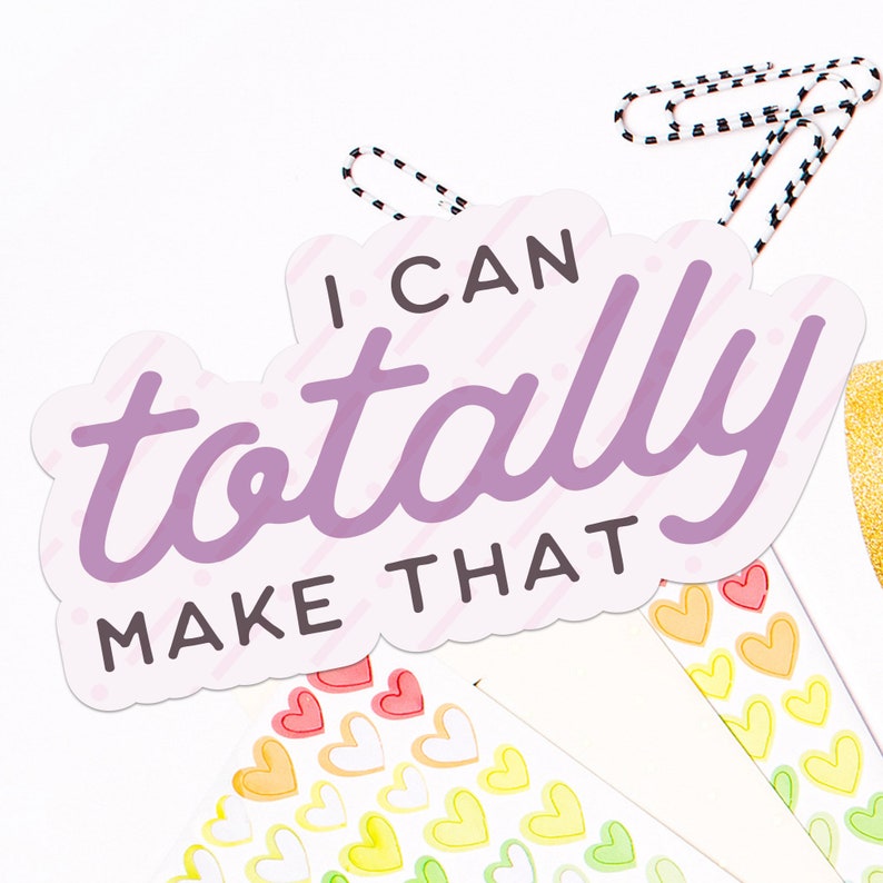 May include: A pink and white sticker with the text "I can totally make that" in purple lettering. The sticker has a striped pattern and is surrounded by small heart stickers.