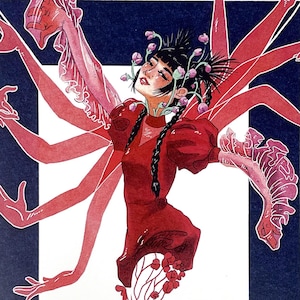May include: Art print featuring a stylized illustration of a figure with multiple arms and a red dress. The figure is adorned with flowers and stands within a white framed rectangle against a dark blue background. The artwork has a whimsical and ethereal quality.
