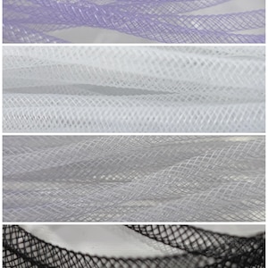 May include: Four different colours of mesh fabric, including purple, white, grey, and black. The mesh is a diamond pattern.