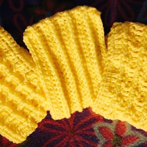 May include: Three yellow crocheted wrist warmers with a textured pattern.