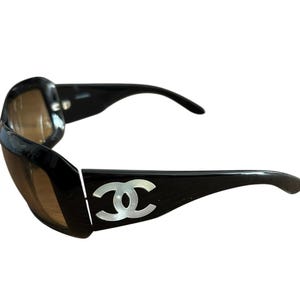 Chanel Jackie O oversized sunglasses mother of pearl CC insets logo Chanel black glasses pearlized side logo amber lenses Chanel sunnies