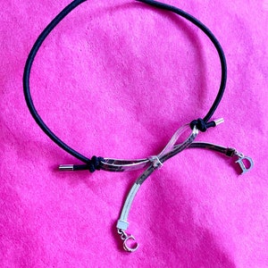Dior silver bow bracelet John Galliano for Dior silver metal bow elastic bracelet silver charms initials black elastic bracelet silver Dior