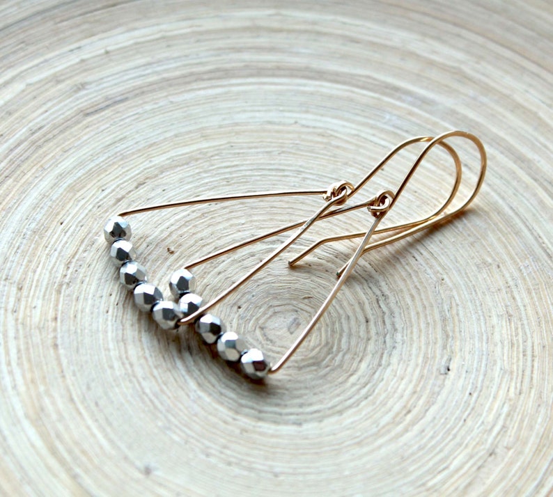 Jewelry trends 2021 Spring gift ideas. Minimalist geometric earrings gold filled and silver triangle shape in mixed metal earrings