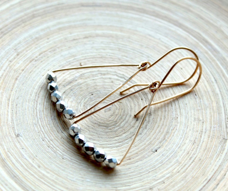 Jewelry trends 2021 Spring gift ideas. Minimalist geometric earrings gold filled and silver triangle shape in mixed metal earrings