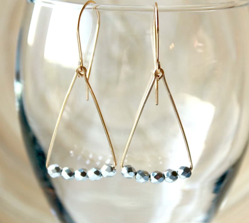 Jewelry trends 2021 Spring gift ideas. Minimalist geometric earrings gold filled and silver triangle shape in mixed metal earrings