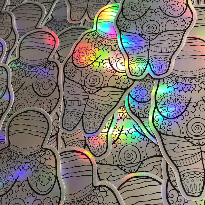 Puede incluir: Un mont&oacute;n de pegatinas hologr&aacute;ficas iridiscentes con un dibujo en blanco y negro de una figura humana estilizada con intrincados patrones. La figura est&aacute; en posici&oacute;n de pie con los brazos a los lados.