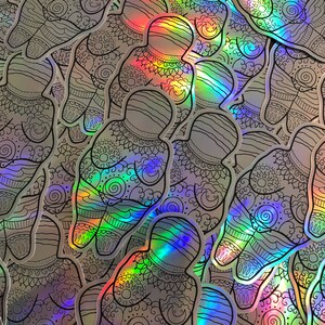 Puede incluir: Primer plano de una pila de pegatinas iridiscentes con un patr&oacute;n repetitivo de una figura humana estilizada con detalles intrincados. Las pegatinas est&aacute;n impresas sobre un fondo transparente y tienen un acabado hologr&aacute;fico.