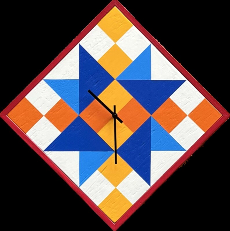 May include: A diamond-shaped wall clock featuring a geometric star pattern in shades of blue, orange, yellow, and white. The clock has a thin red frame and black hands centred on the face. The surface displays a textured, painted wood finish.