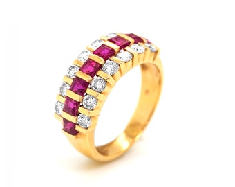 May include: A gold band ring with a row of red rubies and a row of diamonds.