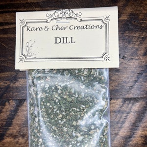 May include: A clear plastic bag filled with dried dill, labeled "Kare & Cher Creations DILL"