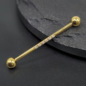 Piercing industrial para andamio con rosca externa, de titanio ASTM F136, con gemas blancas y baño de PVD dorado, 14 g