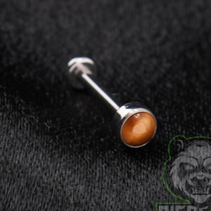 May include: A silver-toned barbell body jewelry piece featuring a smooth, round, amber-colored stone at one end. The metal post is straight and cylindrical, terminating in a flat, circular base. The design is simple, metallic, and polished.