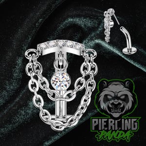 May include: Silver-toned body jewelry with a chain design and clear gemstones. The jewelry includes a curved barbell and a chain with a post. The image also features the text "Piercing Panda".