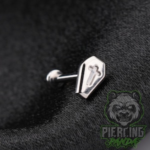 May include: A silver-toned metal body jewelry stud featuring a flat, coffin-shaped top with an embossed cross design in the center. The piece includes a straight post and a circular backing, showcasing a polished metallic finish throughout.