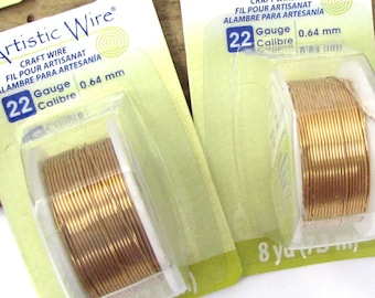 May include: Two spools of 22 gauge gold-colored Artistic Wire, each containing 8 yards of wire. The packaging is green and white with the brand name and gauge information.