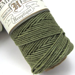 May include: A spool of green hemp cord with a label that reads "Hemp Cord, Premium Quality, Est. 1997, Hemptique".