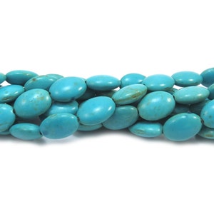 May include: A strand of turquoise oval beads. The beads are a bright, vibrant blue color and have a smooth, polished finish.