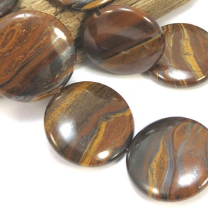 May include: A strand of round, brown and gold tiger eye beads with a metallic sheen. The beads are approximately 20mm in diameter.