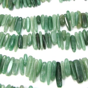 May include: A strand of green jade gemstone beads, each bead is a different shape and size, with a smooth, polished finish.
