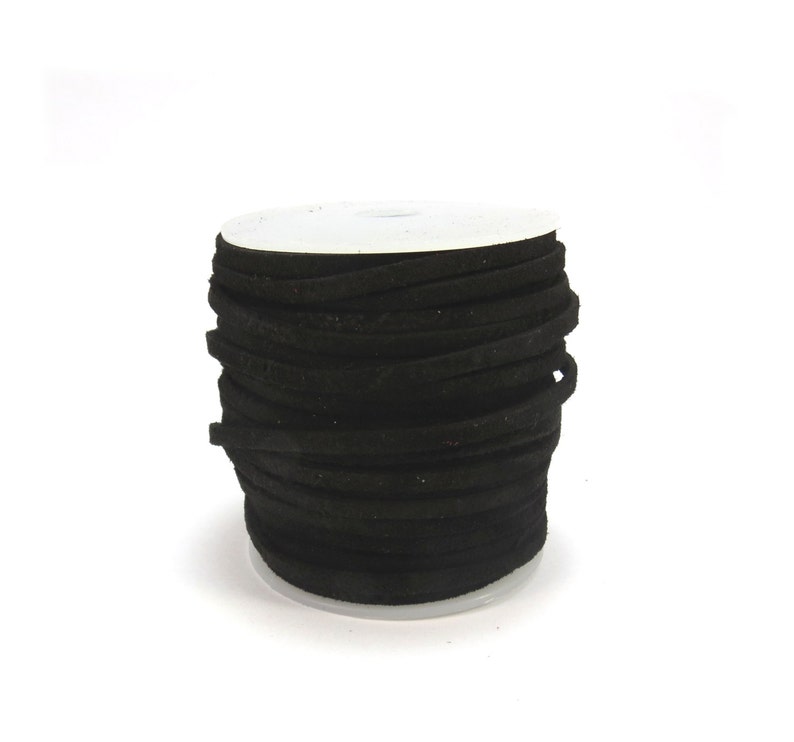 May include: A spool of black suede cord, wound tightly and ready for crafting projects.