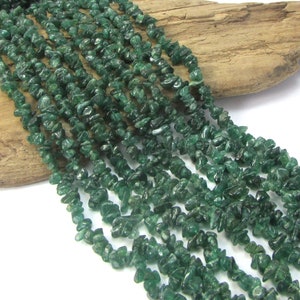 May include: A strand of green aventurine chip beads. The beads are small and irregular in shape, and they have a slightly translucent appearance.