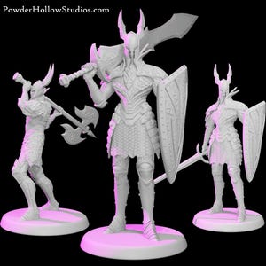 May include: Three unpainted white resin miniature figurines of armoured warriors on circular bases. The figures feature detailed plate armour, horned helmets, and various weapons including a large sword, a battle axe, and a shield. PowderHollowStudios.com.