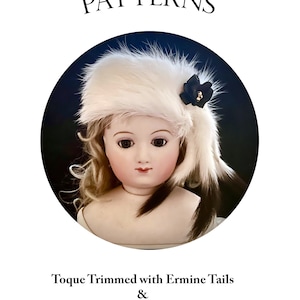 May include: A vintage doll wearing a white fur toque trimmed with ermine tails and a black flower. The doll is wearing a white dress and has blonde hair. The image is from a pattern book for a toque and pelerine pattern by Val Hays.  C'EST LA MODE PATTERNS.