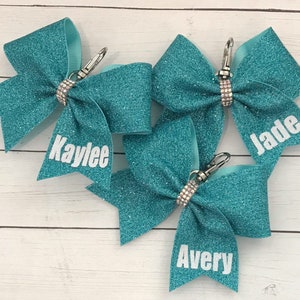 Personalized Cheer Bow Key Chain with Name on Tail only-- Teal 1 Shown, ALL COLORS available. Measures 4x3”.