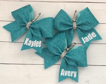 Personalized Cheer Bow Key Chain with Name on Tail only-- Teal 1 Shown, ALL COLORS available. Measures 4x3”.