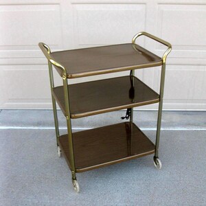 Vtg Metal Rolling Cart -bar cart -3 shelf -faux wood grain -industrial Storage- Deck -electrical cord - Utility cart- serving cart -1950s