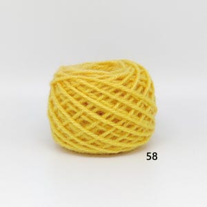 May include: A ball of bright yellow yarn, tightly wound, with a textured surface. The yarn is a solid colour, and the number "58" is printed in black on the bottom right corner. Suitable for knitting or crochet projects.