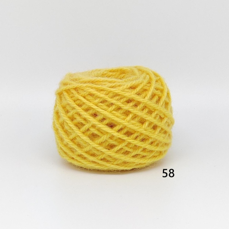 May include: A ball of bright yellow yarn, tightly wound, with a textured surface. The yarn is a solid colour, and the number "58" is printed in black on the bottom right corner. Suitable for knitting or crochet projects.