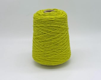 May include: A bright chartreuse yarn cone, ideal for knitting or crochet projects. The yarn is tightly wound around a cardboard core, creating a conical shape. The vibrant green color is eye-catching and suitable for various craft projects.