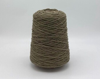 May include: A cone of brown yarn, tightly wound and textured. The yarn appears to be a natural fiber, suitable for knitting or crocheting projects. The cone shape is ideal for easy dispensing during crafting.