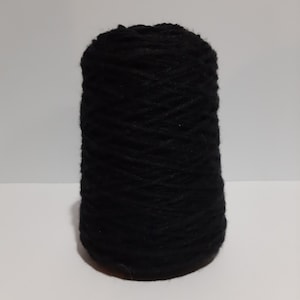 May include: A spool of black yarn.