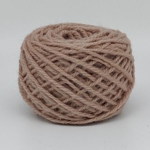 Peut inclure: Une pelote de laine de couleur beige clair.