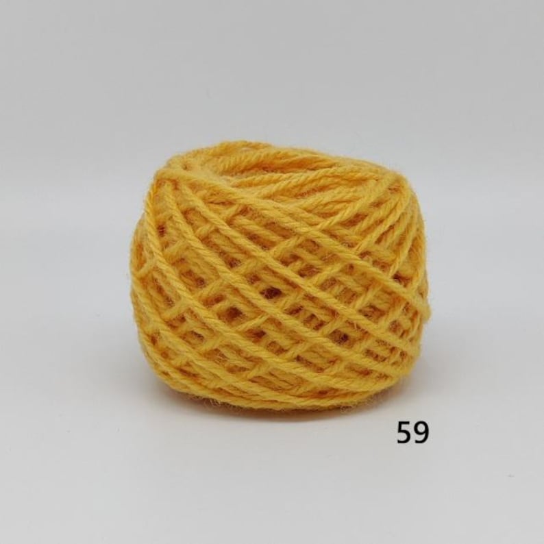 May include: A ball of yellow yarn, tightly wound, with visible strands creating a textured surface. The yarn is a warm, golden colour, suitable for knitting or crochet projects. The number "59" is printed on the bottom right.