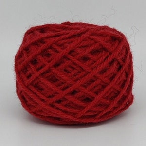 May include: A ball of red yarn, ready for knitting or crocheting.