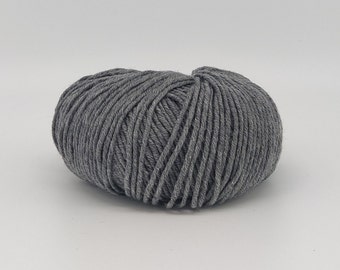 May include: A ball of gray yarn, tightly wound with visible strands. The yarn is a solid, neutral color, suitable for various knitting or crocheting projects. The texture appears soft and inviting.