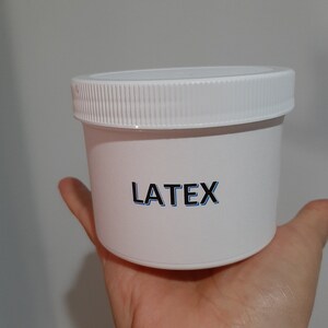 May include: White plastic container with a screw-on lid. The container has the word "LATEX" printed on the front.