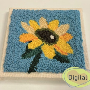 Peut inclure: Une broderie au poinçon représentant un tournesol bleu et jaune avec des feuilles vertes. Le fond est de couleur bleu clair.