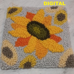 Peut inclure: Un coussin en point d'aiguille gris, blanc, jaune, orange et marron avec un grand tournesol et des petits tournesols autour.