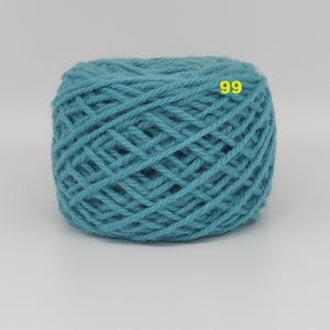May include: A ball of teal yarn with a woven texture. The yarn is a solid color and has the number "99" in yellow on the surface. This yarn is suitable for knitting and crocheting projects.